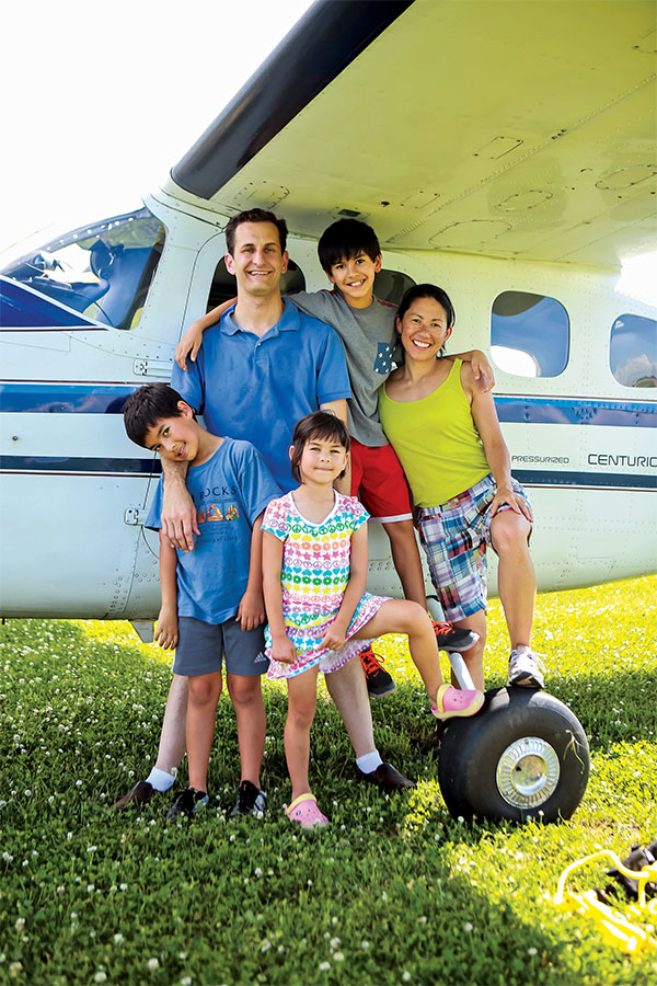 family on north 40 in front of plane