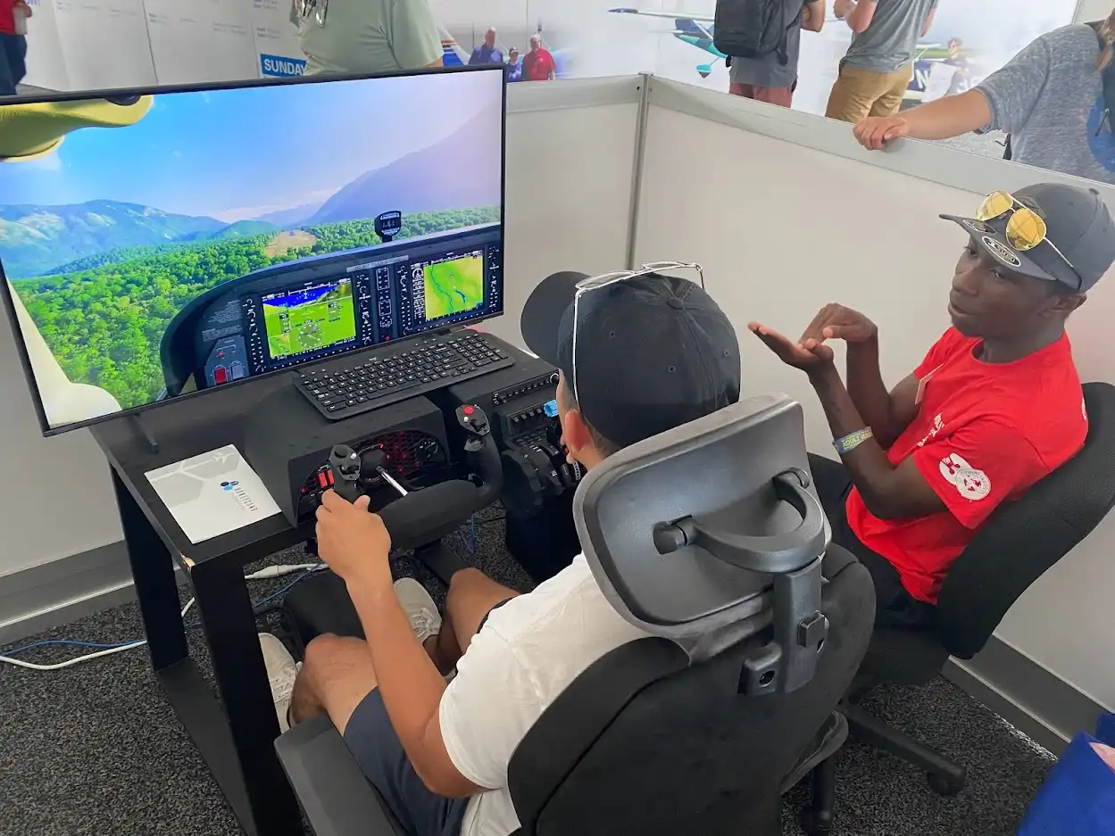 Certified Flight Instructor Teaching Pilot on Aviation Simulator during AirVenture | EAA Learn To Fly Center