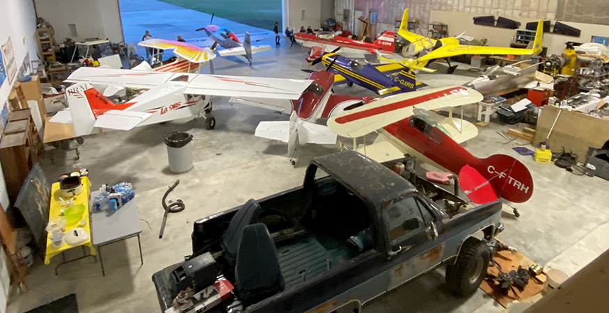 Some of the acro airplanes sharing hangar space with some non-acro vehicles