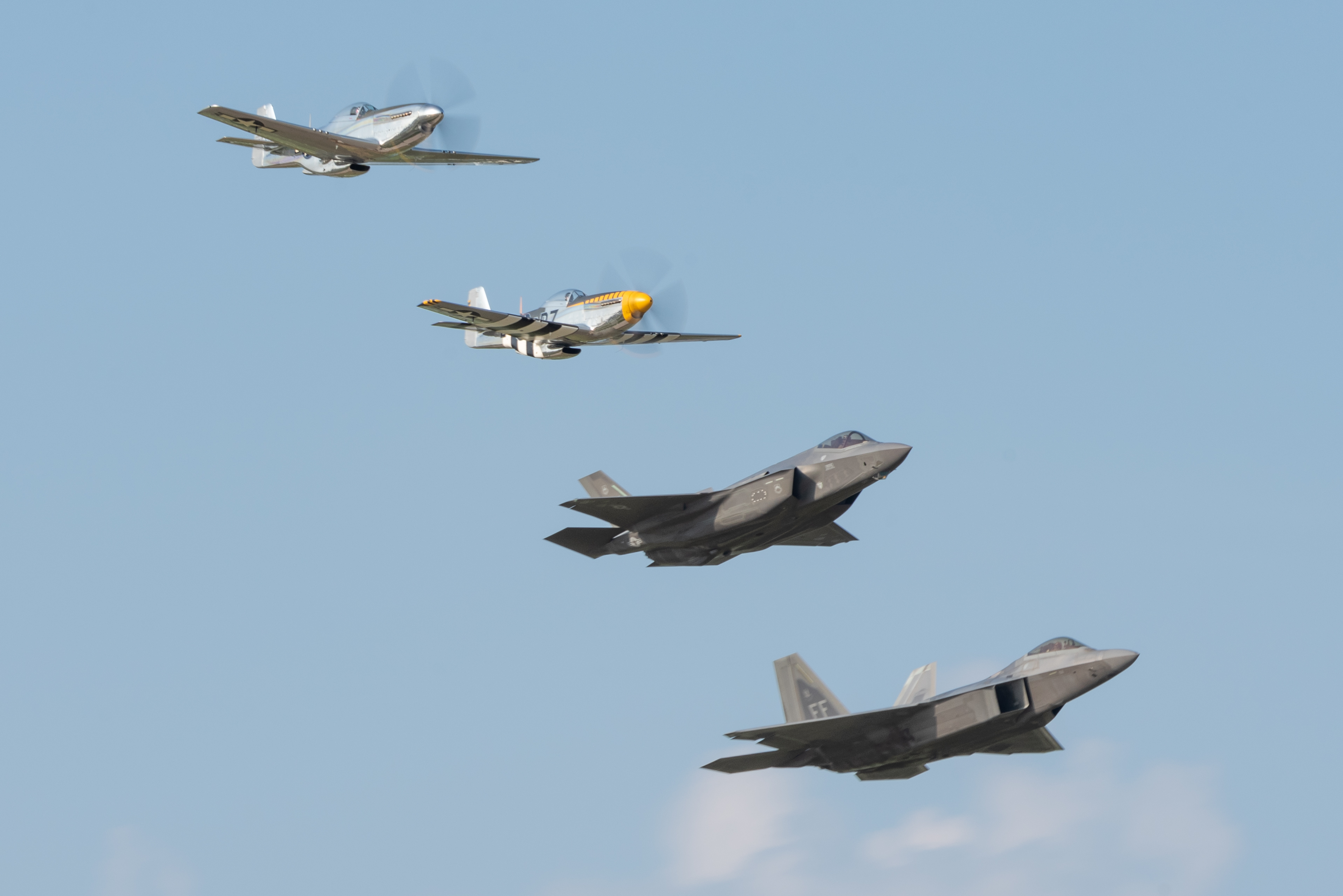 f22 demo team flying at airventure oshkosh with p51 mustang and f35